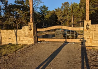 a gate with a wooden frame and a shadow on the ground