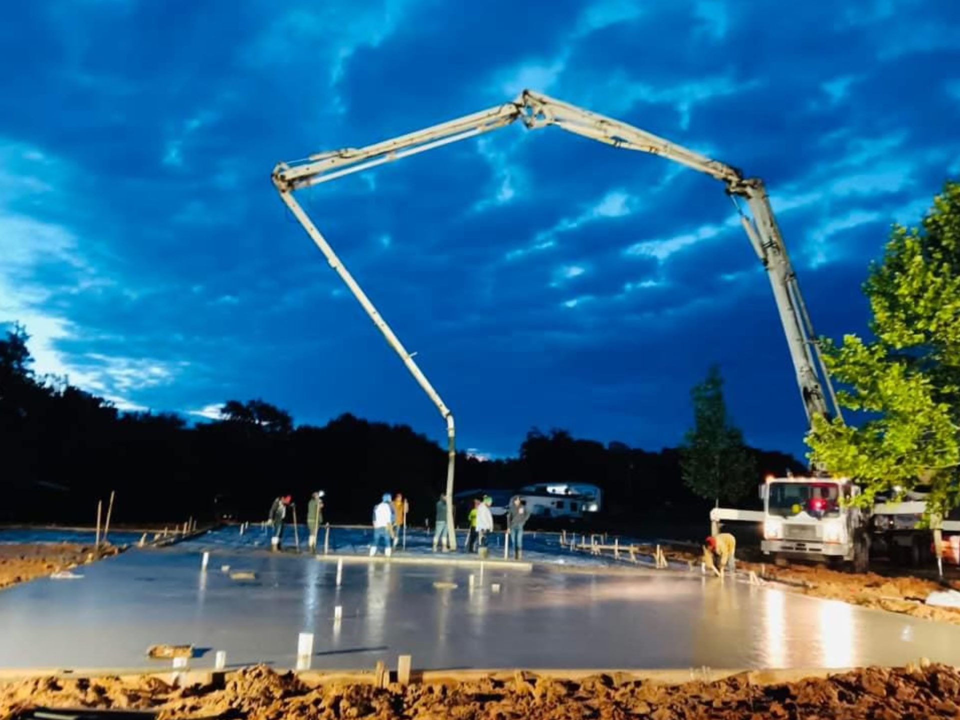 A man pouring concrete onto a concrete slab to create a solid foundation for construction.